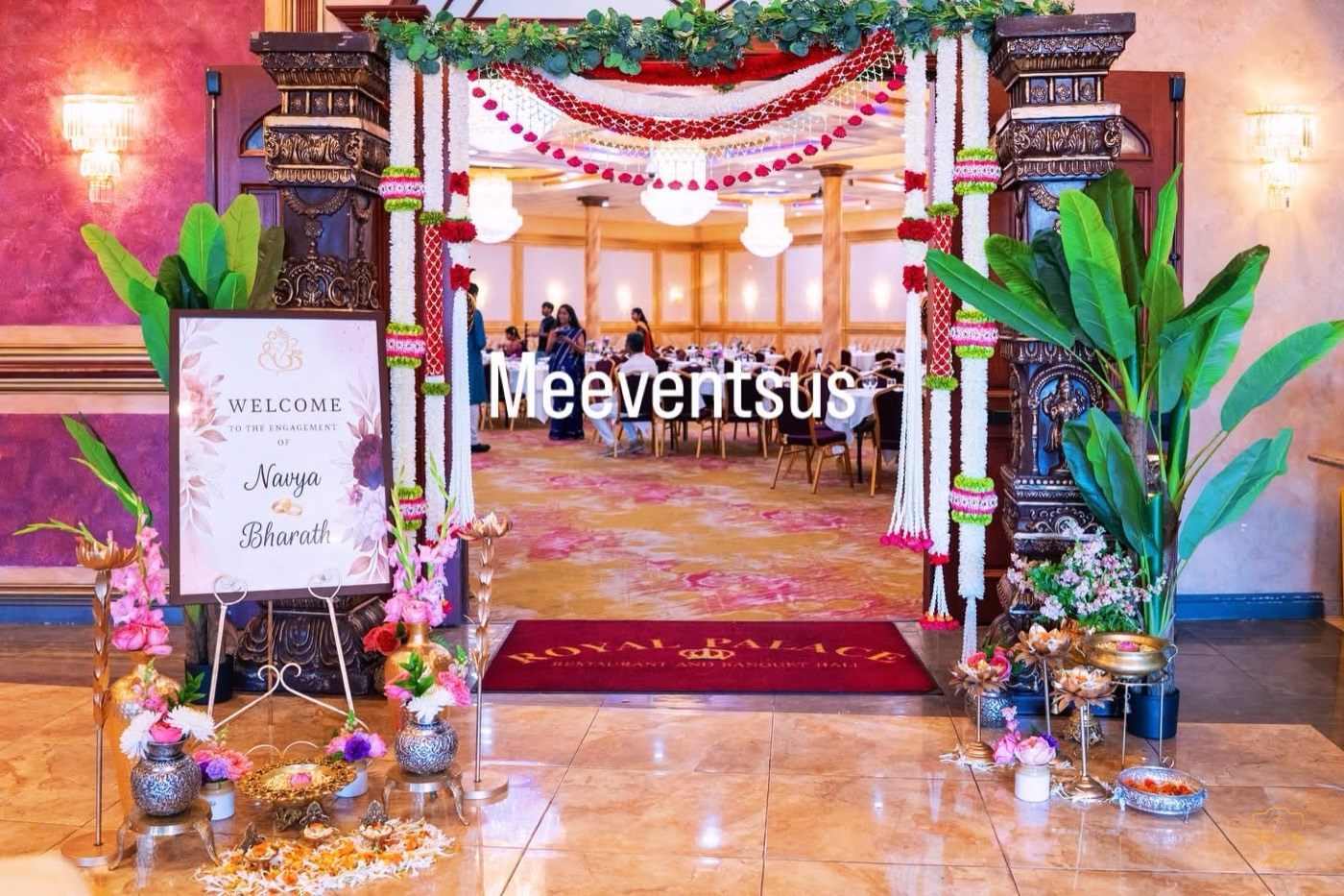 Engagement entrance with floral pillars and welcome sign